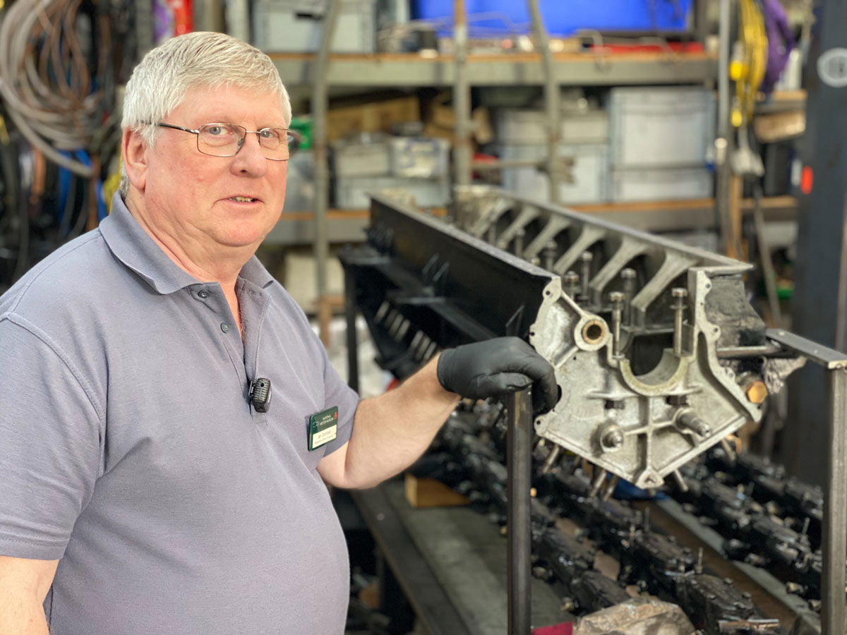 Senior Engineer Ian Stanfield With Rear Engine Crankcase In Workshop