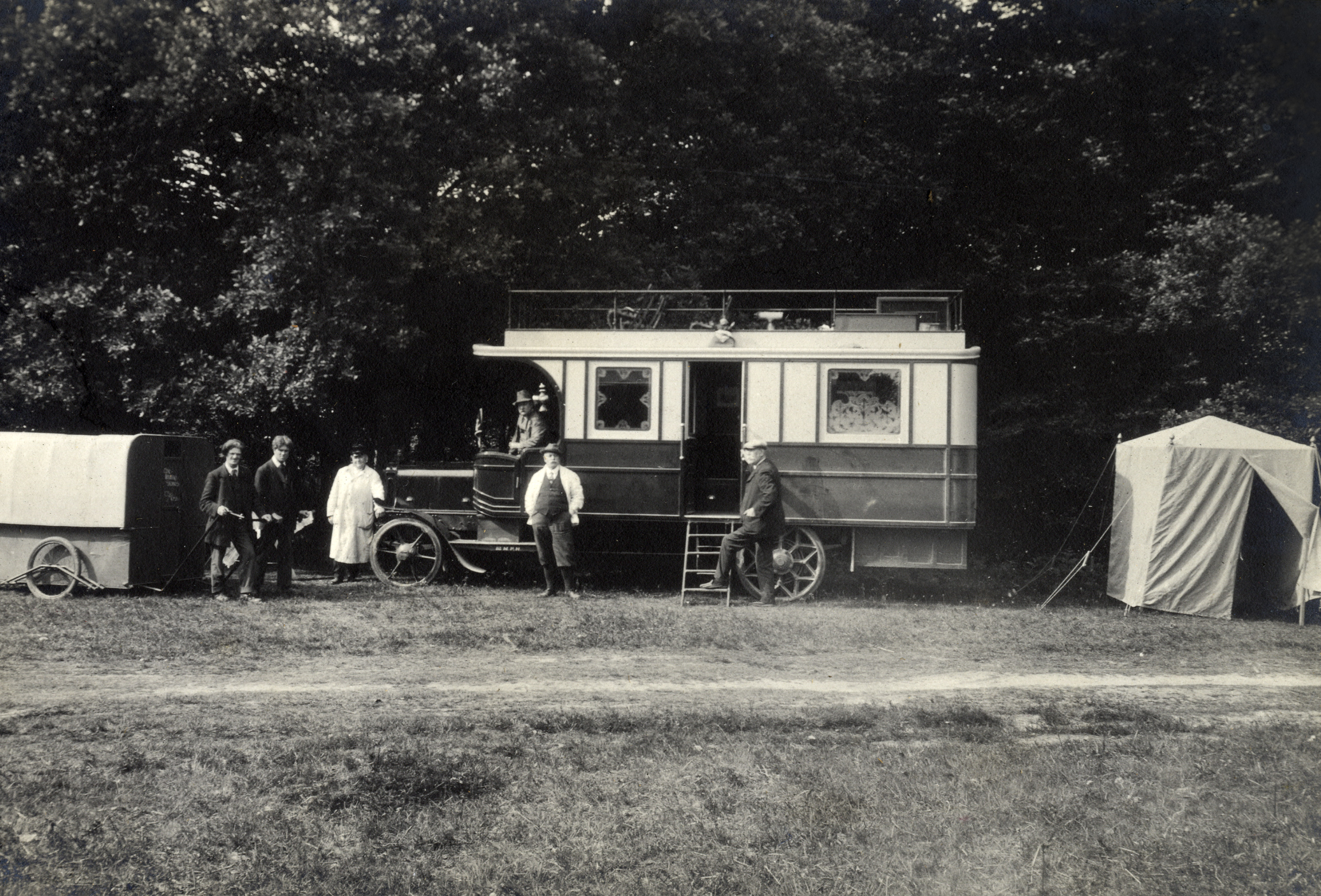 1913 Daimler Chassis Motor Caravan at the Caravan Club meet with men standing around it